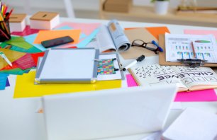 Designer&amp;#39;s table with notes and tools .