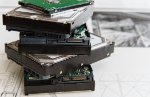 pile of old hard drives at white background